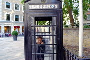Back in the street, in the phonebooth.